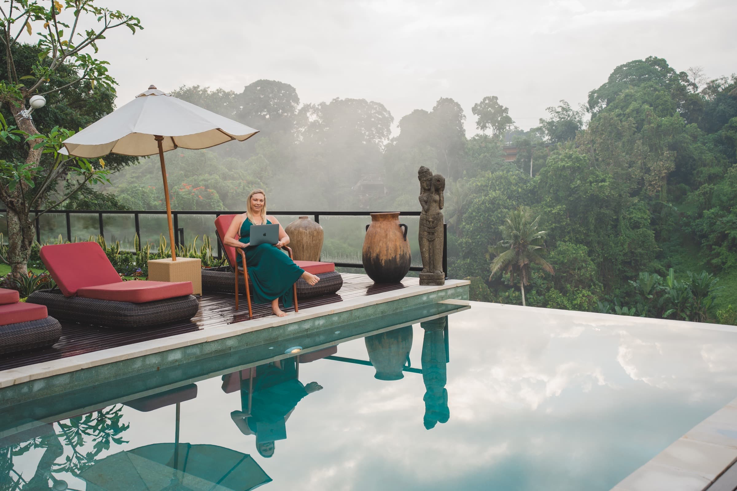 Sheree working from a poolside terrace overlooking the jungle